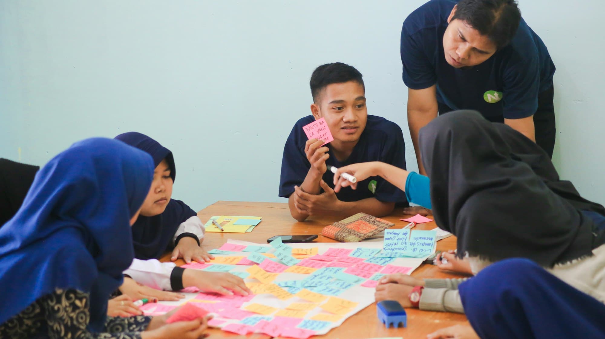 A community group planning a project with sticky notes on a table